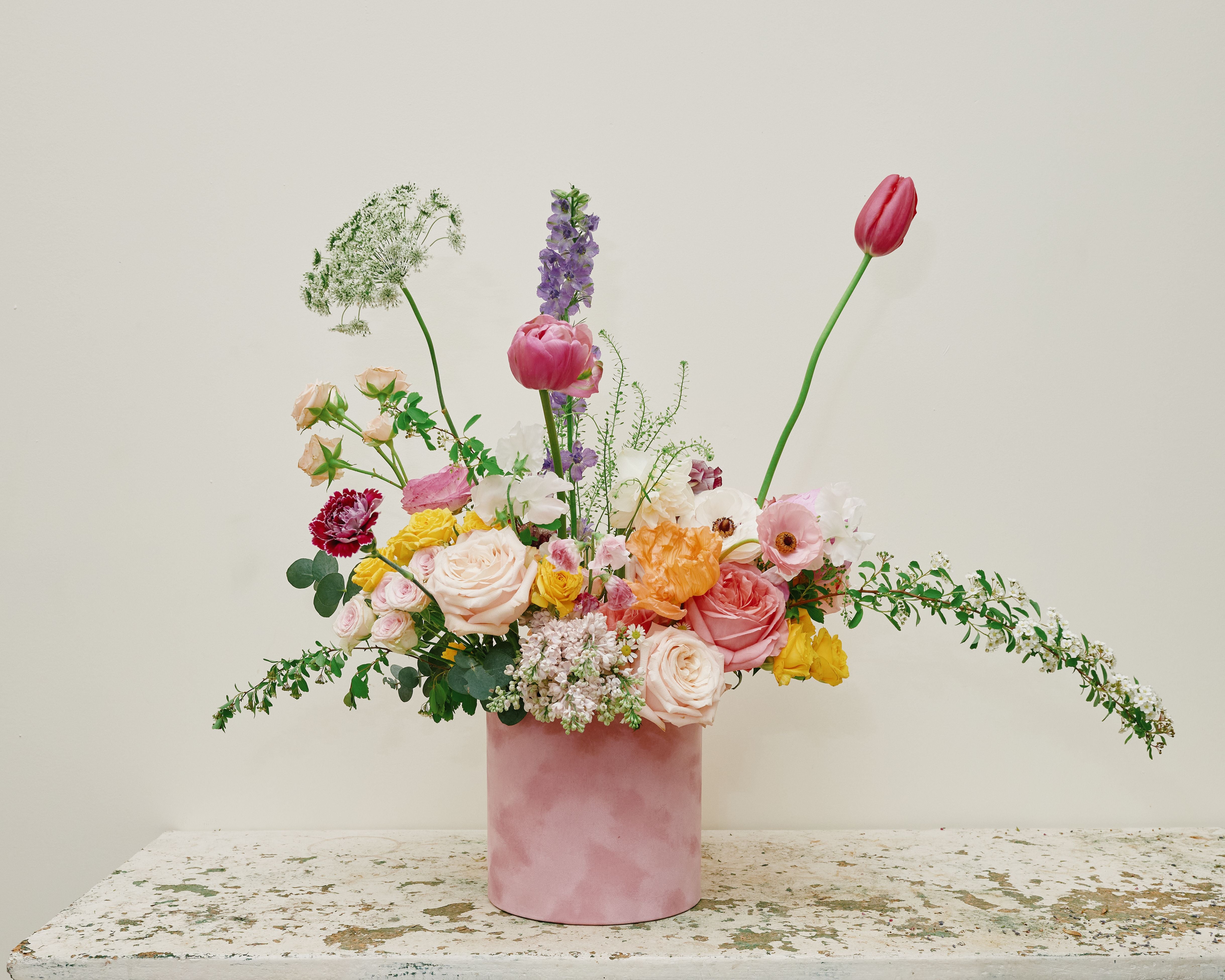 Garden style flowers styled in a pink velvet box 
